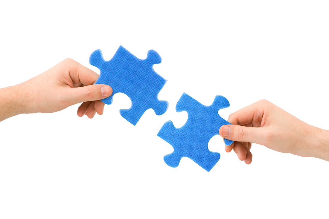 Two people placing puzzle pieces together